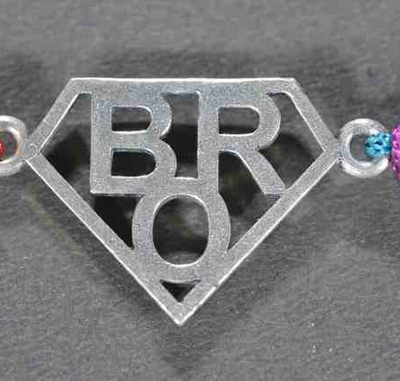 A silver Rakhi with a stylish design featuring the word "BRO.