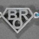 A silver Rakhi with a stylish design featuring the word "BRO.