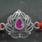 A 925 sterling silver Rakhi featuring an intricate design with a central red stone for Raksha Bandhan.