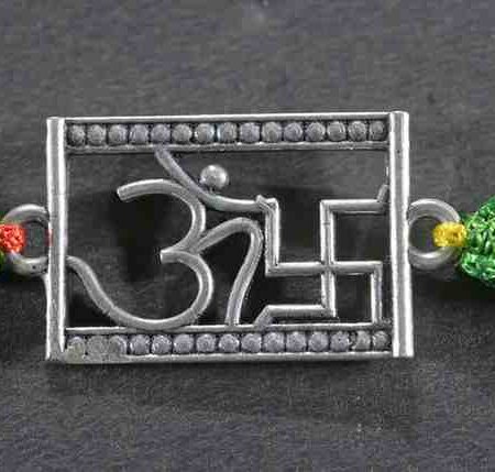 A silver Rakhi featuring divine symbols of Om and Swastik