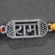 A silver Rakhi featuring a divine depiction of Lord Ram