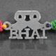 A silver Rakhi featuring a stylish design with moustache and goggles motifs