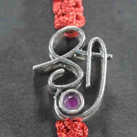 A silver Rakhi featuring the word "Shree" adorned with cutstone embellishments.