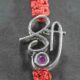 A silver Rakhi featuring the word "Shree" adorned with cutstone embellishments.