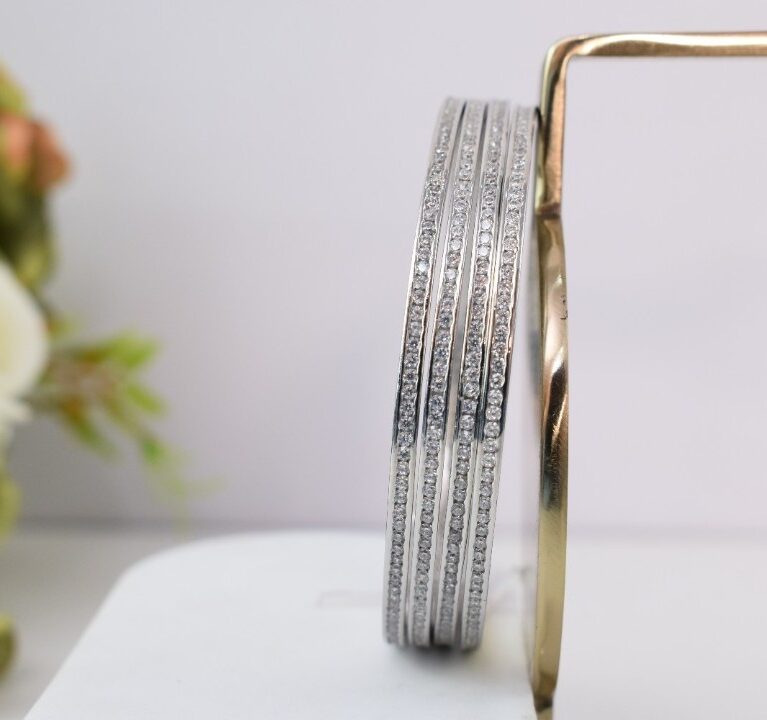 A set of silver bangles adorned with rows of sparkling CZs.